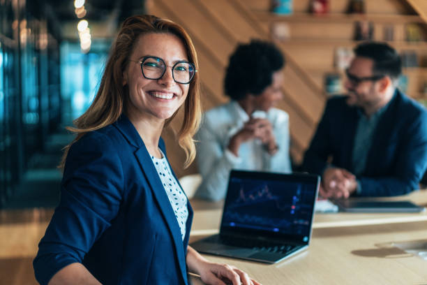 Young woman at the computer looks over her shoulder