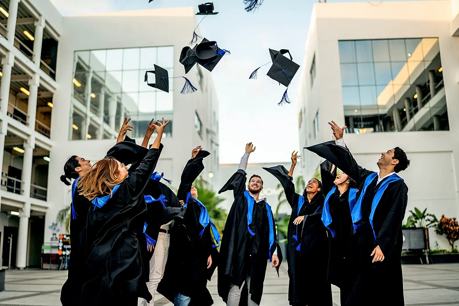 Bachelor's hats are thrown into the air by a group of students
